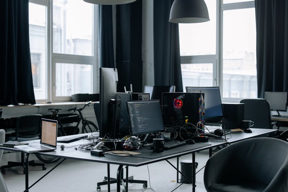 Contemporary workspace featuring computers, coding screens