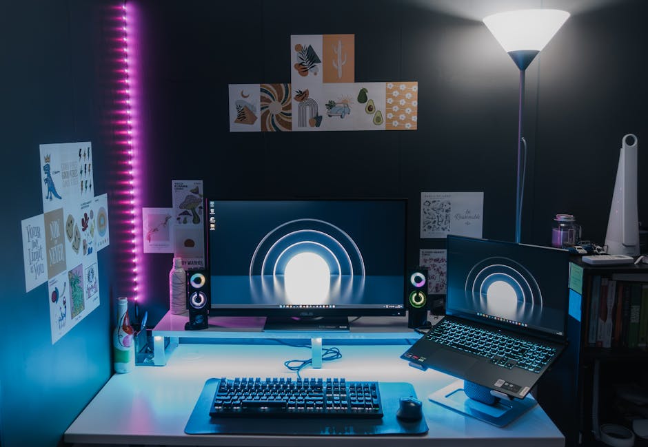 Stylish gaming setup featuring dual monitors, LED lighting, and tech accessories