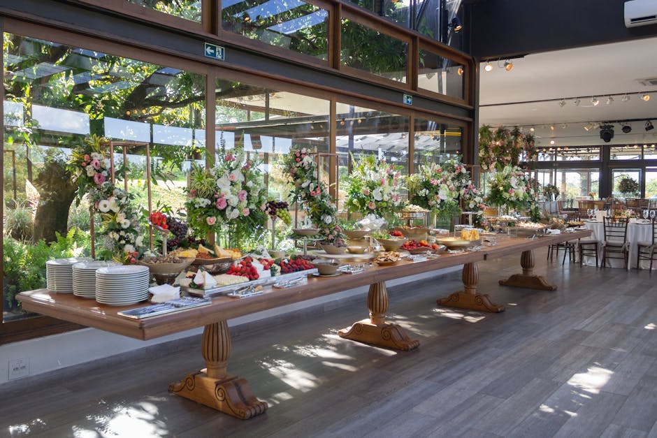 An elegant indoor buffet in São Paulo featuring floral arrangements and assorted foods for a special event